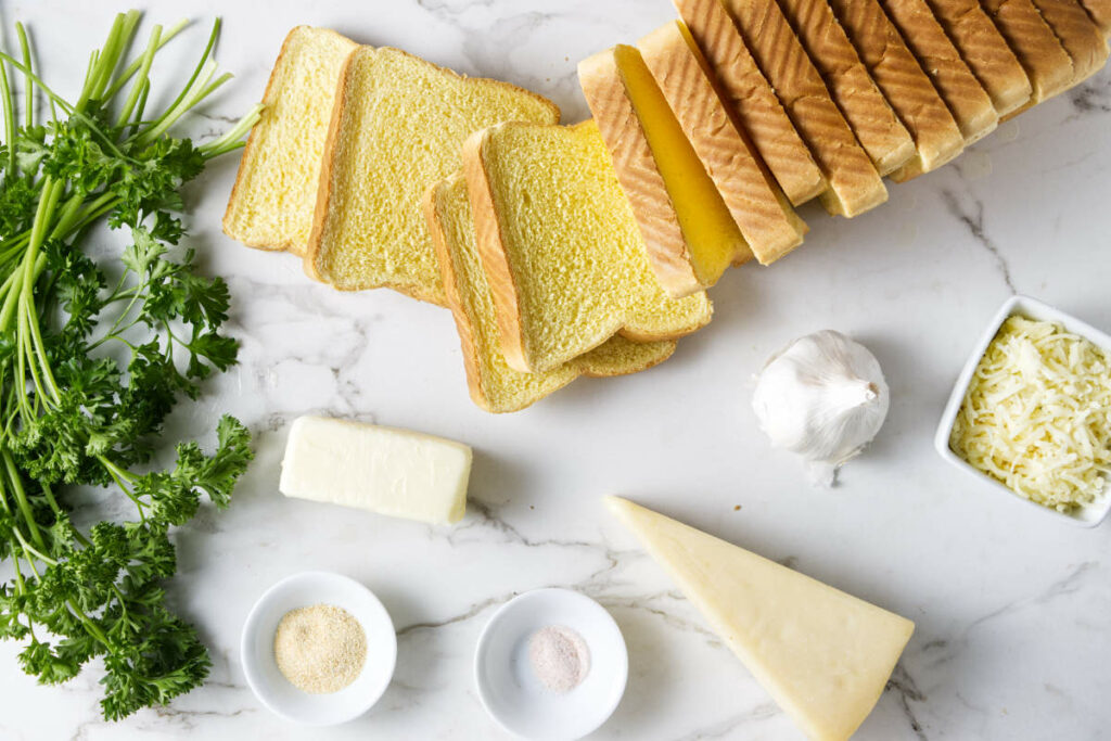 Texas toast sandwich bread, garlic, Parmesan cheese, salt, butter, garlic powder, and fresh parsley.