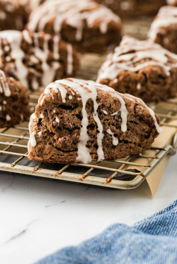 A banana chocolate chip scone with glaze on top.