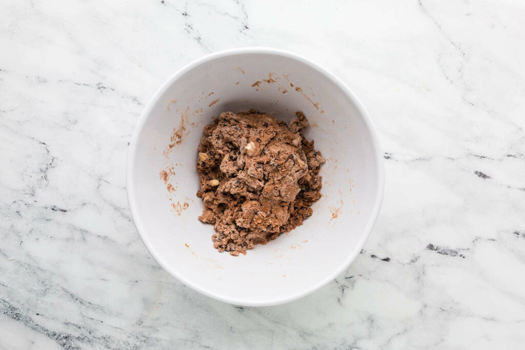 Combining the wet and dry ingredients in a mixing bowl.