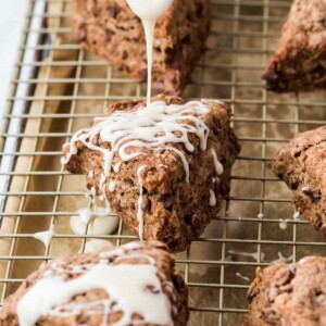 Drizzling a glaze over chocolate scones.
